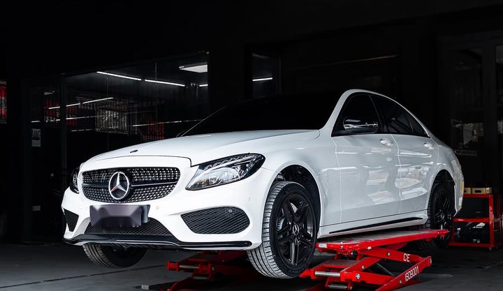 White Mercedes-Benz C-Class (W205) on a workshop lift